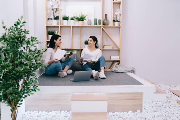 istock Cheerful coworkers working with papers in stylish room 1473510121