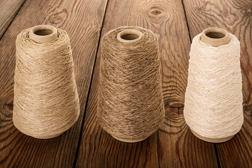Bobbins of yarn  on  wood background