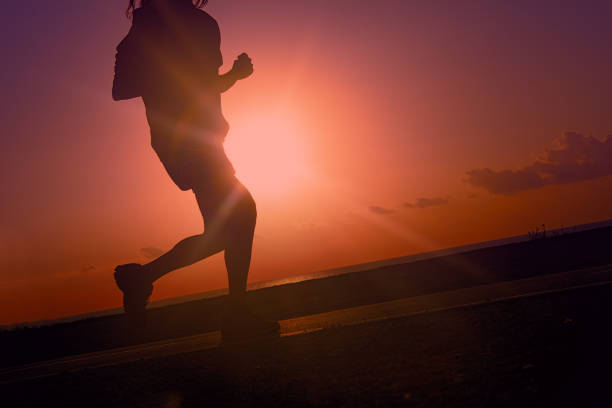 Sports Jogging on beach against setting sun, evening jog. Healthy lifestyle, Amateur sports and sporting appearance, aesthetic pleasure