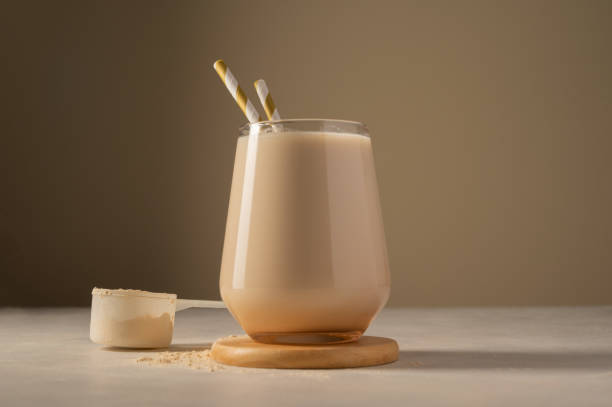 gesundes schokoladen-protein-shake-getränk mit stroh und proteinpulver - superfood stock-fotos und bilder