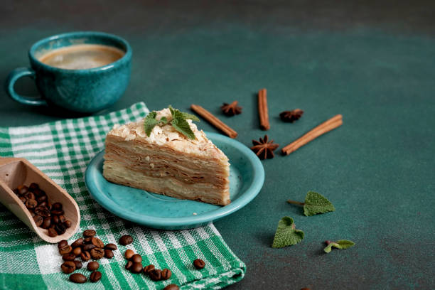 istock Layered Cake with cream Napoleon with mint on green background. Copy space 1473512415