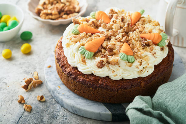 Easter Carrot cake with cream cheese frosting. Delicious carrot cake with walnut and cream cheese frosting on gray concrete background table for festive dinner. Traditional carrot cake. Easter food. Easter Carrot cake with cream cheese frosting. Delicious carrot cake with walnut and cream cheese frosting on gray concrete background table for festive dinner. Traditional carrot cake. Easter food. easter cake stock pictures, royalty-free photos & images