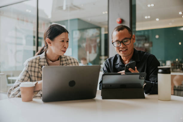 istock Smiling Two co-owner talking about their business. 1473513443
