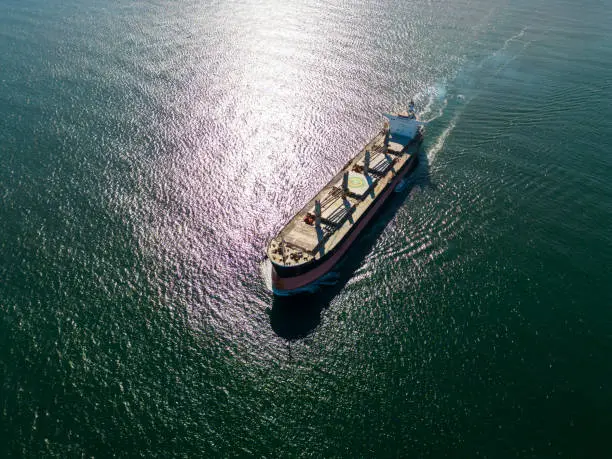 arge bulk carrier transports grain at sea, aerial top view