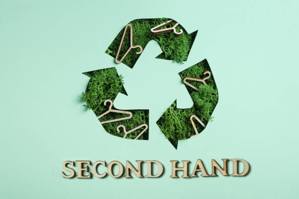 istock Second hand text and green moss under paper cut recycling symbol. Save planet, eco, recycling cloth concept 1473519391