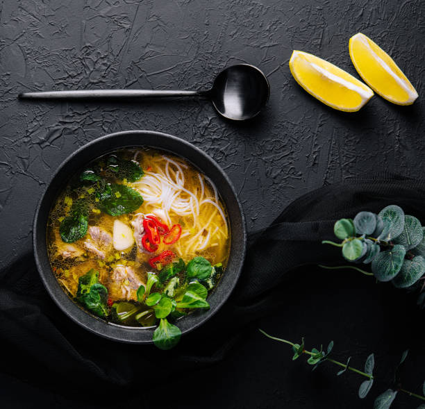 istock Chicken soup with vegetables in black bowl 1473519502