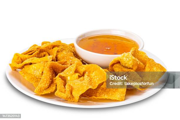 Pile Of Crispy Delicious Homemade Deep Fried Wontons In White Ceramic Plate And Sweet Dipping Sauce In White Ceramic Cup Stock Photo - Download Image Now