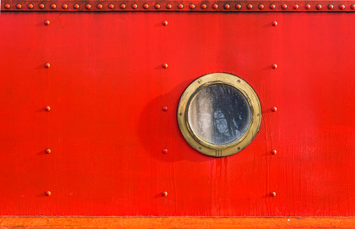 porthole in red narrowboat