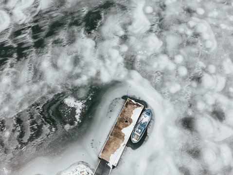 The drone image captures the beauty and magic of winter, with the snow and ice transforming the familiar pier into a wonderland of white and blue. Taken in Padva, Finland.