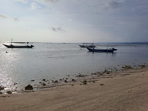 Landscape with beach sea view, sand, and fishing boat, laguna beach, kaur, indonesia