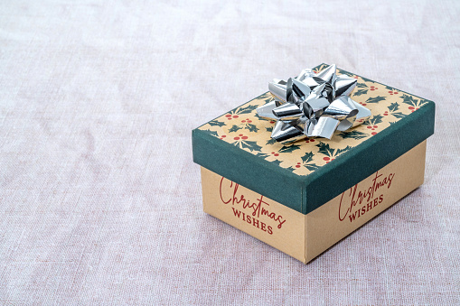 A Christmas gift box with a silver bow