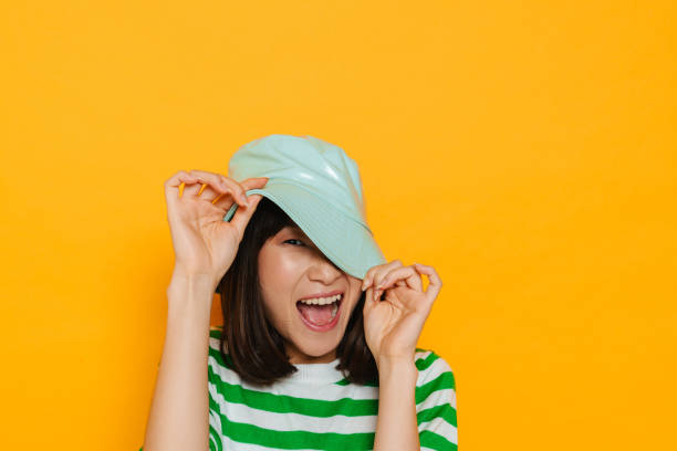 istock Asian young woman laughing while making fun with panama 1473524512