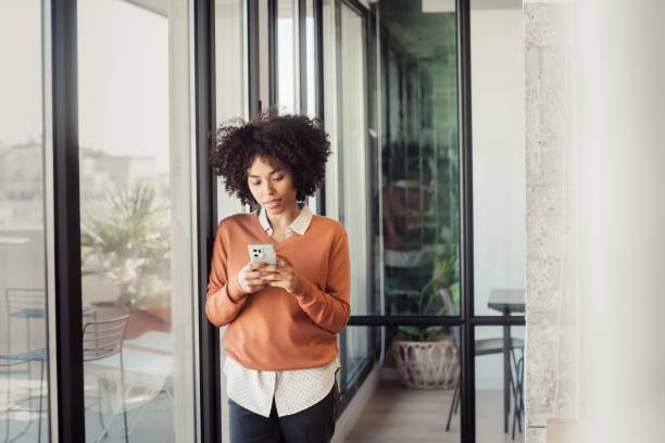 istock Young woman in office smiling while working 1473525585