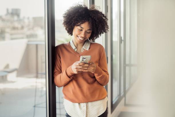 istock Young woman in office smiling while working 1473525590