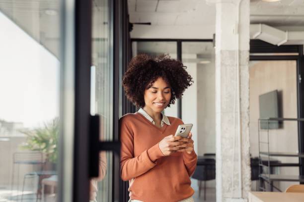 istock Young woman in office smiling while working 1473525623