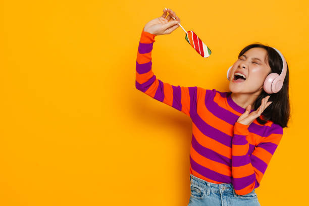 istock Asian brunette woman smiling and holding grapefruit 1473526183