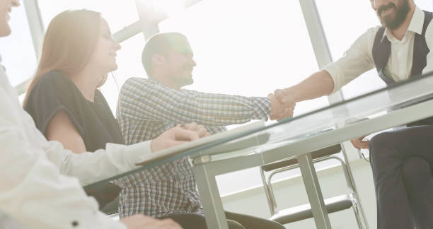 istock business partners shake hands during a working meeting 1473527110