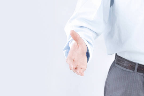 istock young businessman holding out his hand for a handshake. 1473528458