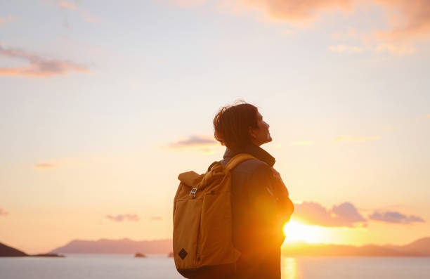 istock Woman resting alone over the sea shore, 1473528475