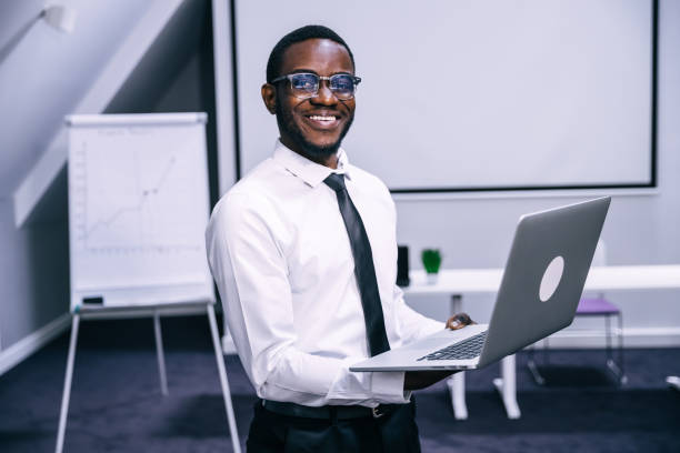 istock Handsome cheerful african american executive businessman in office workspace 1473530202