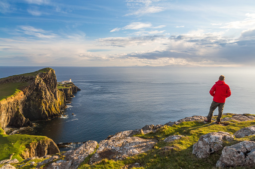 Man admiring the view,lighthouse, Neist Point, Isle of Skye, Highland Region, Scotland, United Kingdom