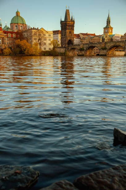 landscape with Vltava river and Karlov most in the evening in autumn in Prague, Czech Republic.