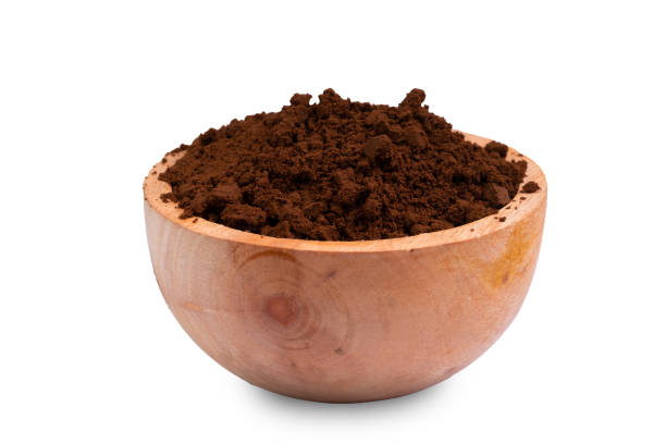 istock Coffee grounds in a wooden bowl isolated on white background. 1473530596