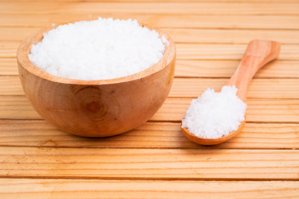 istock Sea salt in a bowl on a blurry kitchen background 1473530743