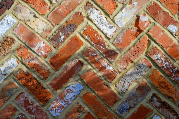 Red brick wall with herringbone design stock photo