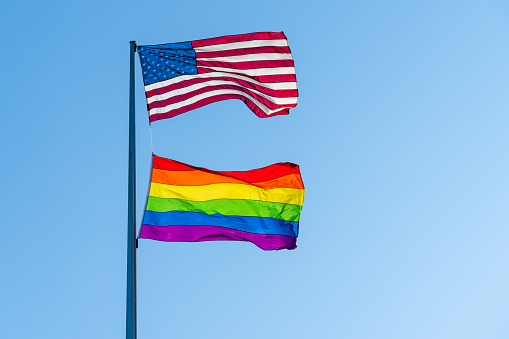 Low Angle View Of Flags Against Clear Blue Sky