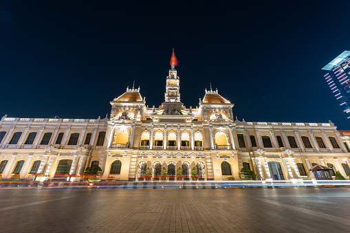 Traffic in front of Ho Chi Minh City Hall, Saigon City Hall or Committee Head office in the evening, Vietnam. Light trail and night. Popular place to visit in Saigon. Travel destinations in Vietnam