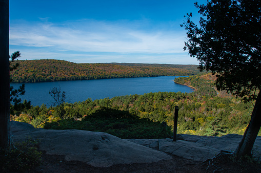 A view of the lake and surrounding forest in Algonquin Provincial Park from a cliff
