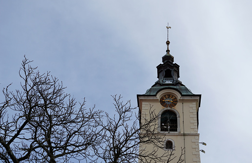 Old church steeple shot against white background.