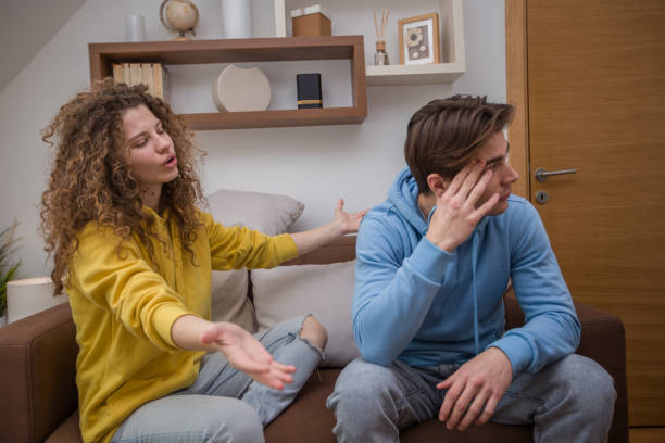 istock Young stressed couple fighting while sitting on couch in living room 1473539011