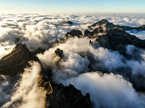 Mountain peaks peek out from the clouds