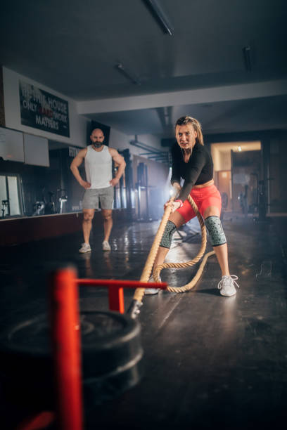 istock male athlete pushing and pulling  the sled in the gym 1473539653