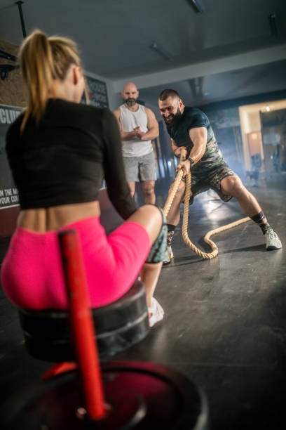 istock male athlete pushing and pulling  the sled in the gym 1473539718