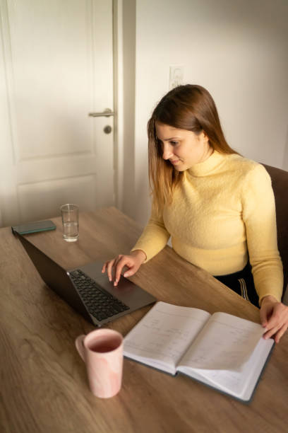 istock Woman studying and working online on lap top. 1473542200