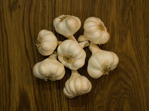 Garlic placed in wooden  isolated white background suitable to highlight its nutritious and medicinal value.