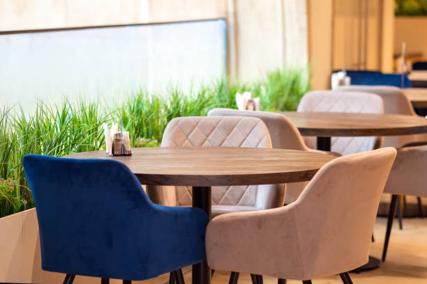 istock Round table with soft armchairs around bright day 1473543390