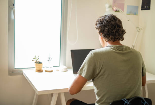 istock Back side of man do his work at desk at bedroom. 1473543467