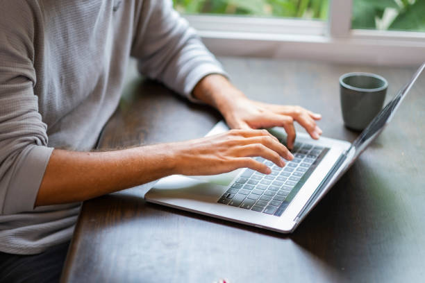istock Crop man hand in top view using laptop. 1473543575