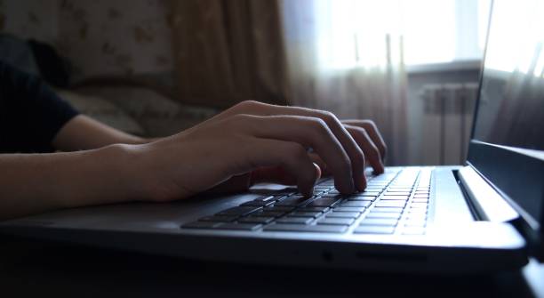 istock side view hands typing on a laptop, a person writing an email, working from home, working on the internet, copywriter 1473543639