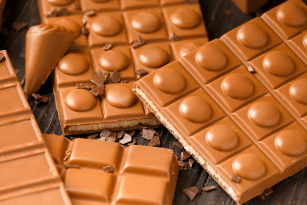 istock Milk chocolate bars and candies on a dark background. 1473543827