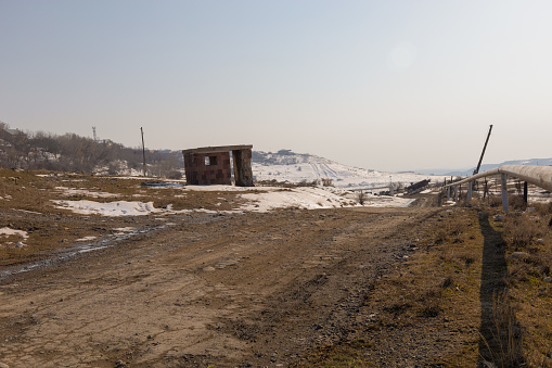 Rural panorama with dirt road on a clear sunny day in winter