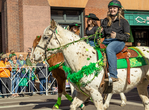 Denver, Colorado - March 11, 2023: St. Patrick's day parade in Denver, Colorado. Horse riders.