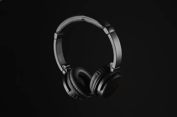 istock Black wireless stereo headphones isolated on black background 1473546078