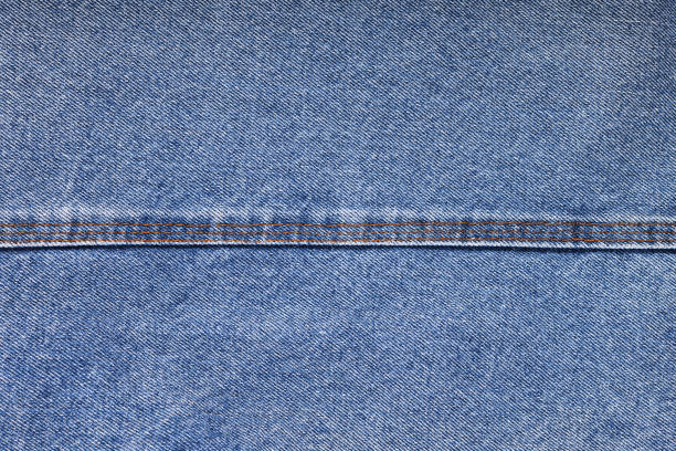 istock Blue jeans background and texture close up.Denim seam. 1473546582