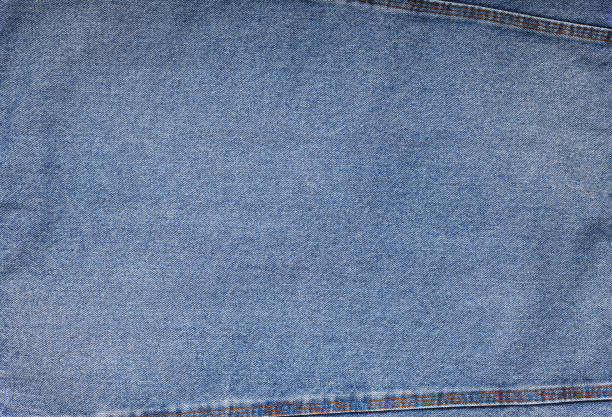 istock Blue jeans background and texture close up.Denim seam. 1473546584