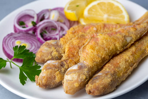 istock Plate of fried small fish red mullet and lemon 1473547298